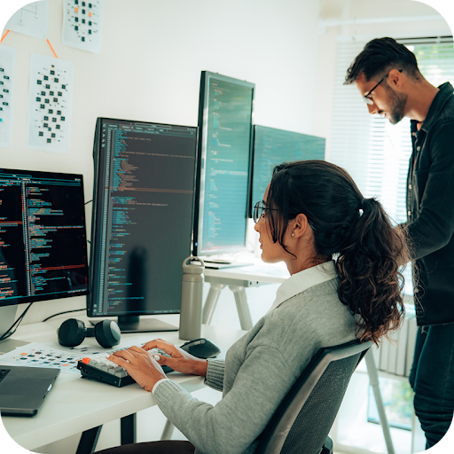 Two colleges typing on a computer at Invoca.